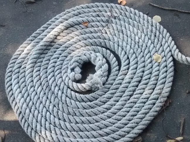 A rolled-up mooring line, waiting for his tourist boat to return. Aug. 2016. (c) 2016, JSB*Art. All Rights Reserved.